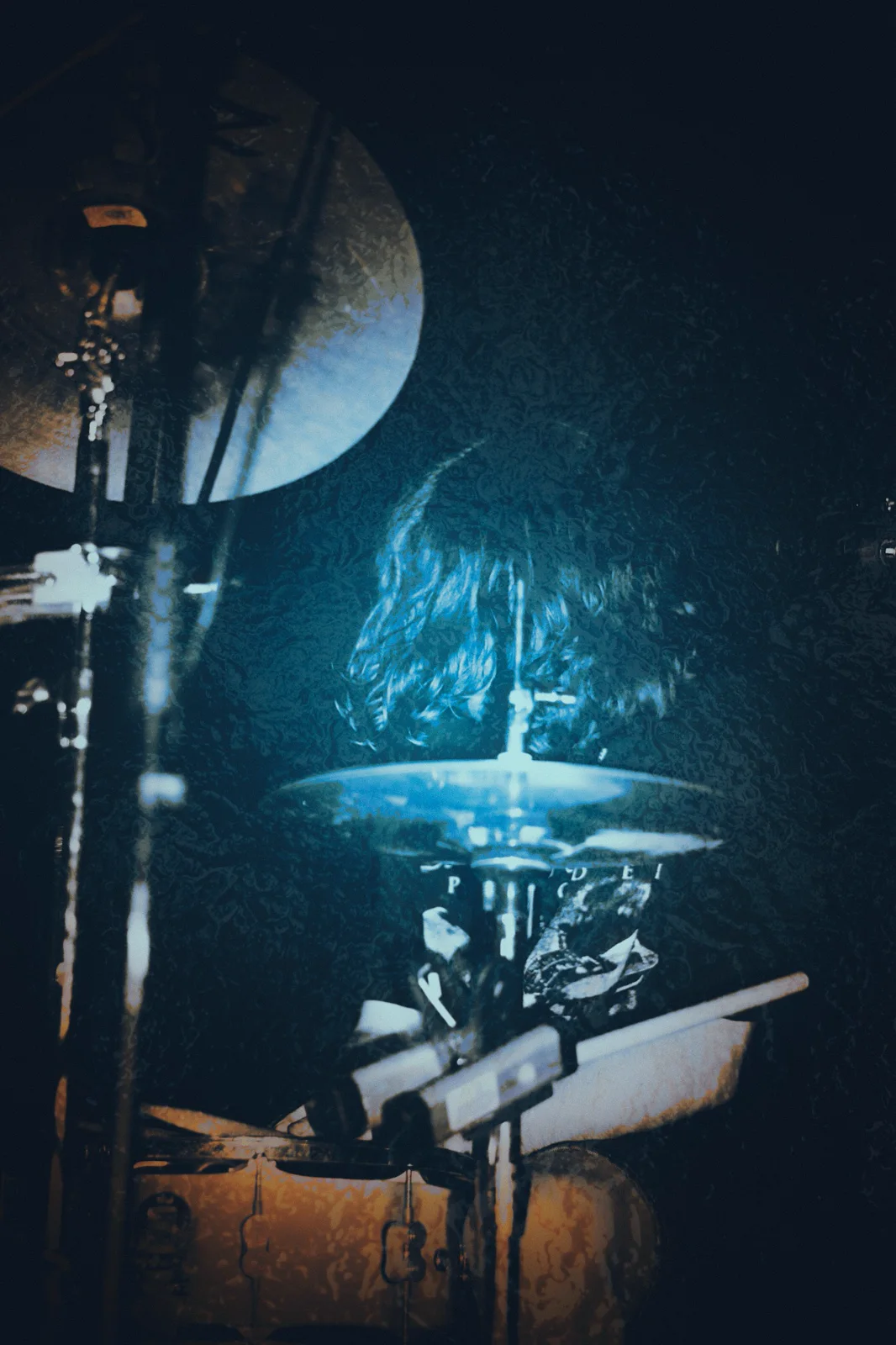 Drummer photographed in atmospheric stage light