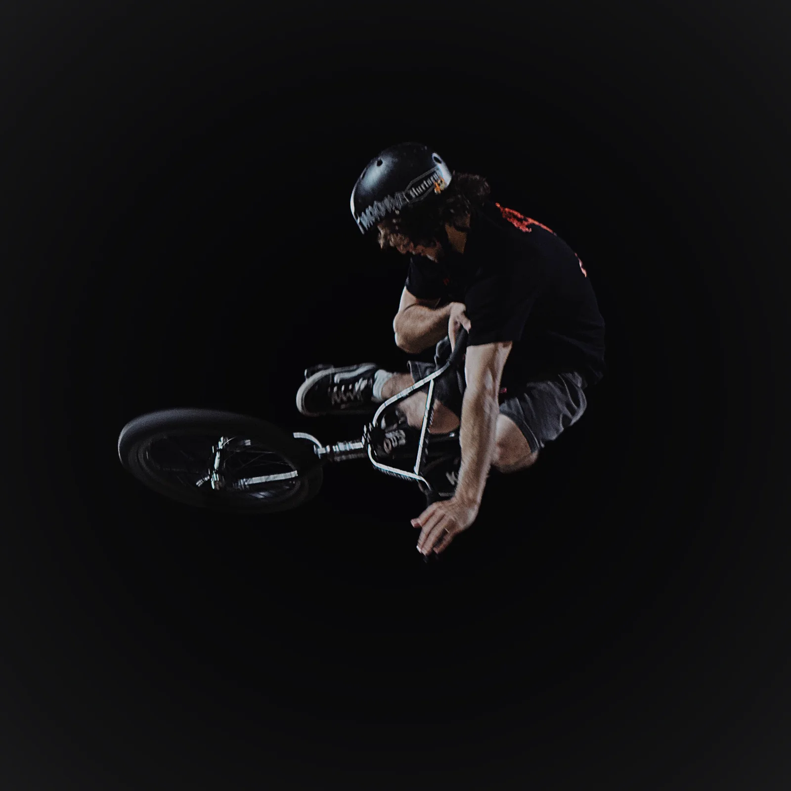 Lucas airborne on a BMX at night