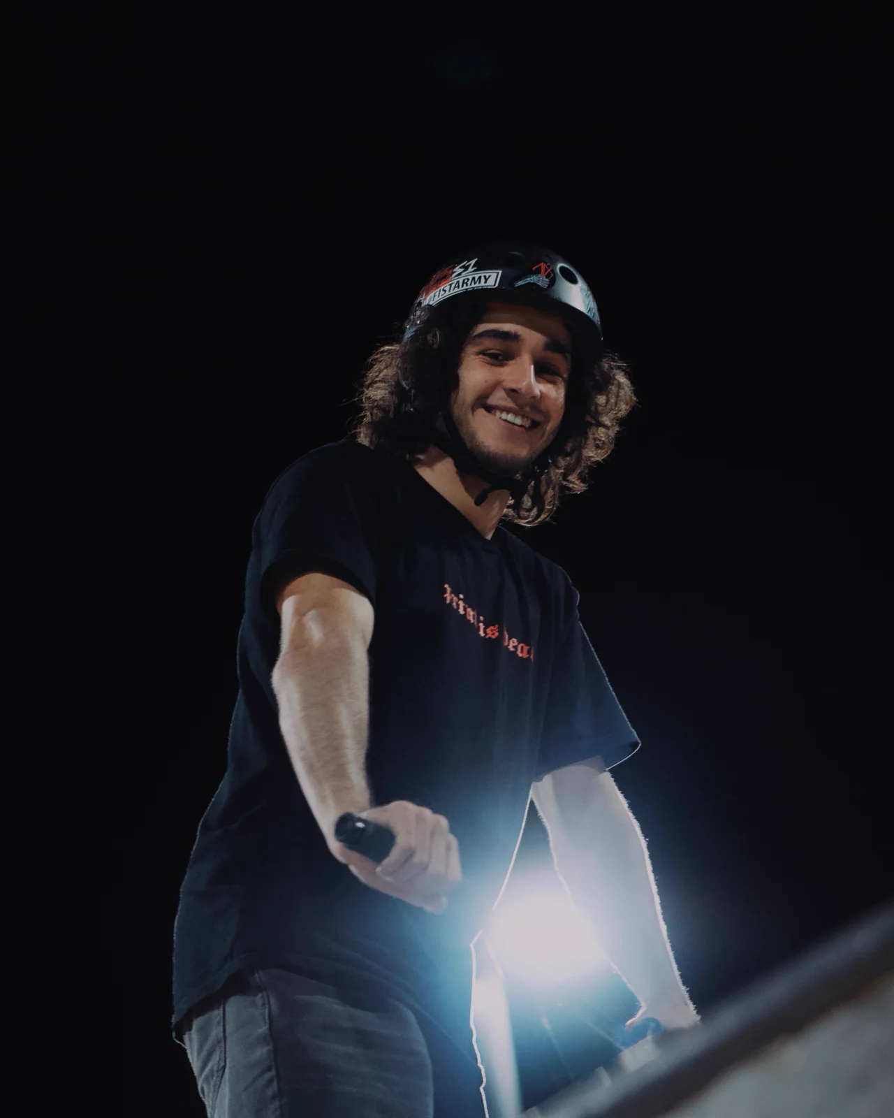 Lucas smiling with a skate park light behind him
