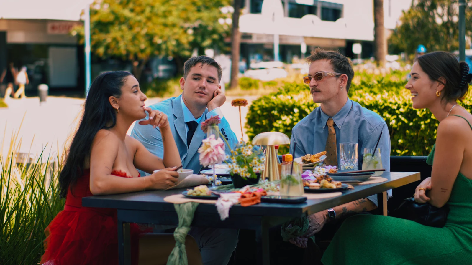 The couple and guests talking around a reception table